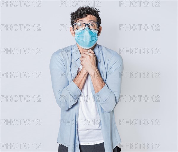 Latin man begging with medical protective face mask. pleading man concept isolated
