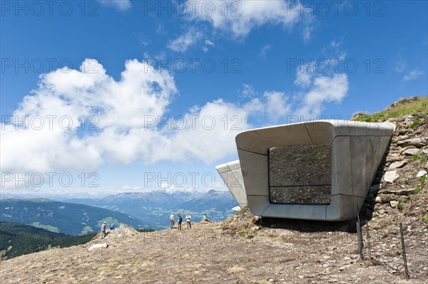 Two large futuristic windows rise out of the mountain