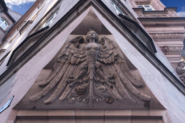 Relief of a mixed creature on a residential and commercial building erected in 1902