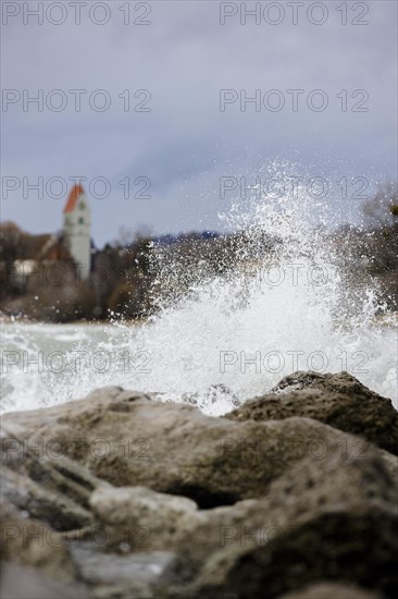 Storm Lolita whips waves against the stony shore in the background Hagnau