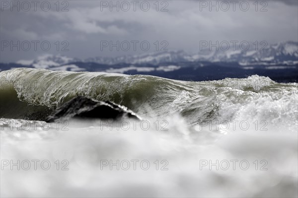 Storm Lolita raging on the rocky shore with waves in Hagnau