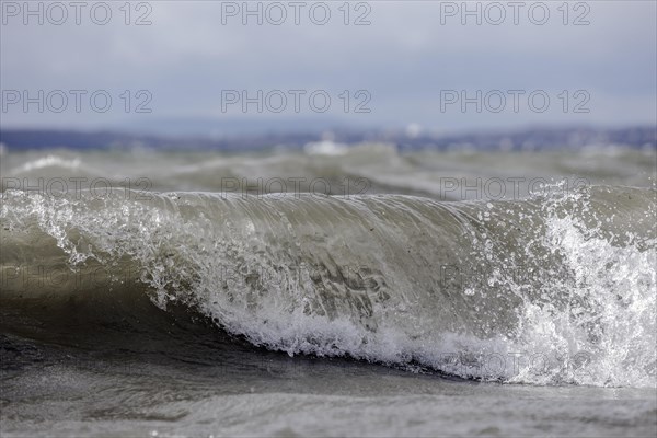 Storm Lolita raging on the rocky shore with waves in Hagnau