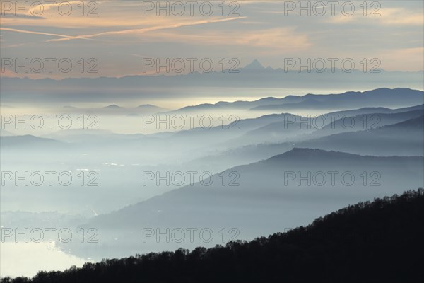 View from Pizzoni di Laveno on silhouettes of mountain ranges with Monte Viso in the distance