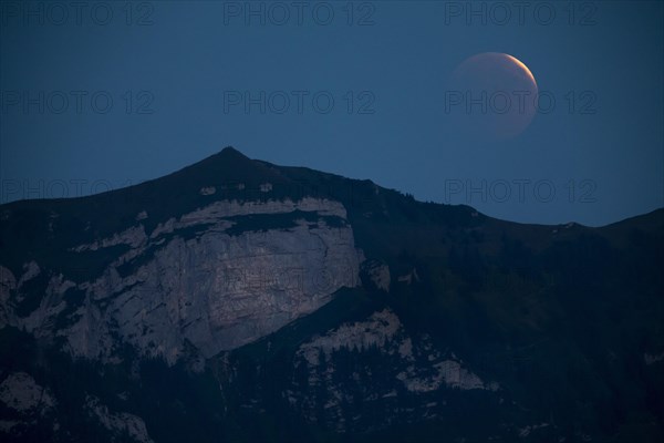 Lunar eclipse above the mountain station of Hohen Kasten