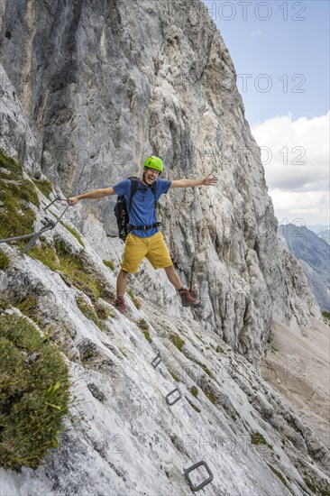 Young man stretching out his arms and legs