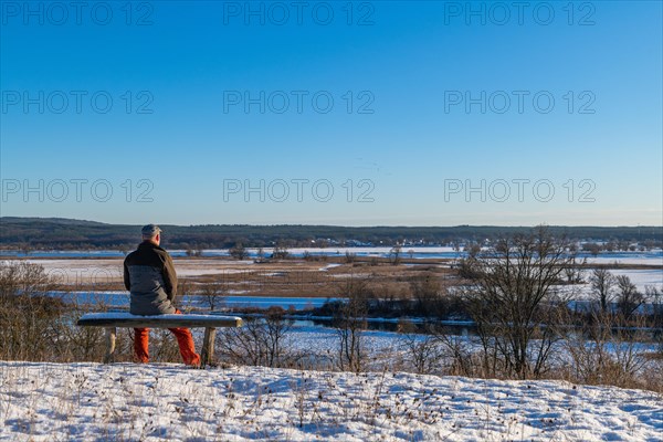 Hiker on a bench in the snow