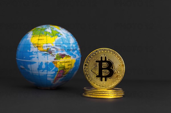 Bitcoin BTC crypto currency gold coin and Earth globe