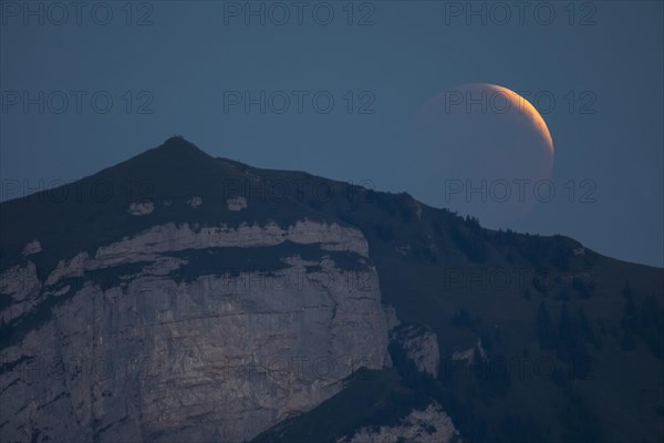 Lunar eclipse above the mountain station of Hohen Kasten