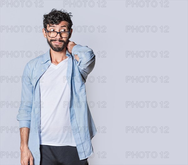 Latin young man with awkward face isolated on white background