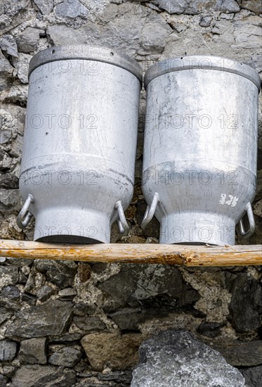 Milk cans at an alpine pasture in the Eng