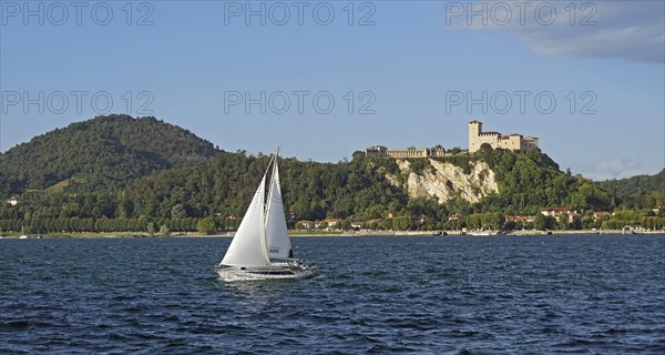 Sailing boat and castle of Angera or Rocca Borromeo di Angera