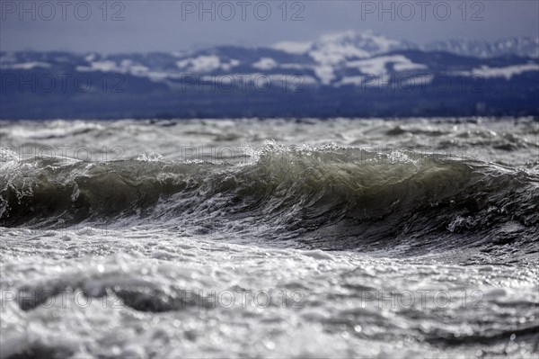 Storm Lolita raging on the rocky shore with waves in Hagnau