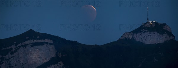 Lunar eclipse above the mountain station of Hohen Kasten