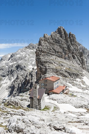 Alpine refuge Rifugio Pedrotti and chapel with rock Croz del Rifugio