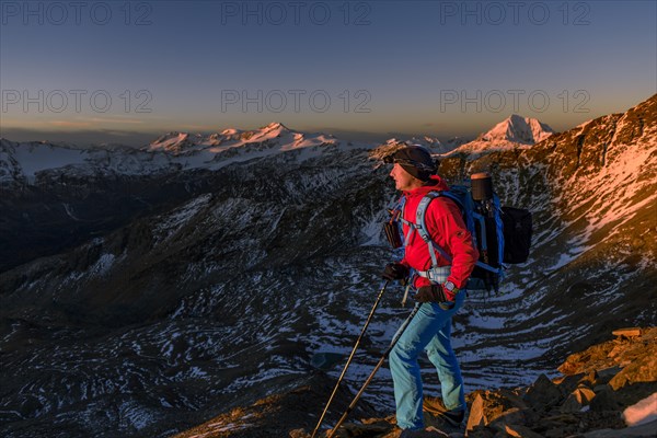 Mountaineers in front of snowy peak of Monte Cevedale in morning light