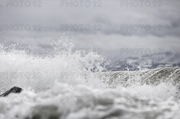 Storm Lolita raging on the rocky shore with waves in Hagnau