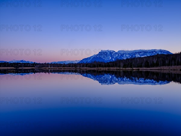 Untersberg at dusk reflected in the moor lake in Ainringer Moor