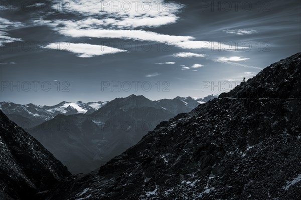 Mountaineers on mountain ridge in the background glaciated mountains