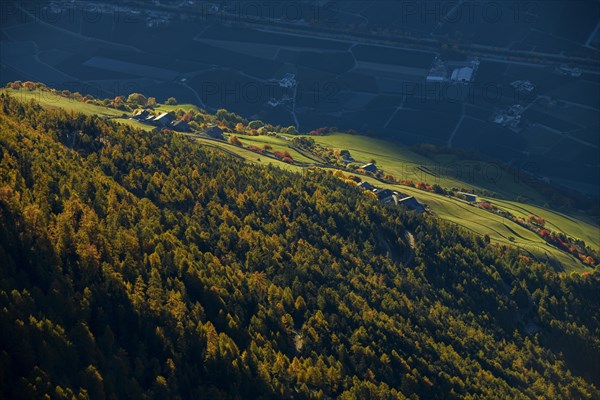 Mountain farm on mountain meadow with larch