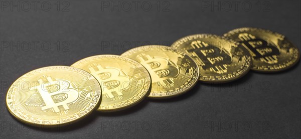 Bitcoin BTC crypto currency gold coins on black background