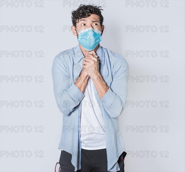 Latin man begging with medical protective face mask. pleading man concept isolated