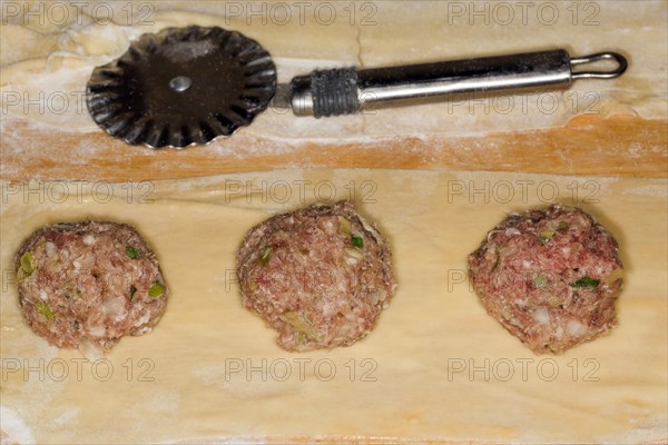 Maultaschen filling of beef and pork meat on a thin pasta dough