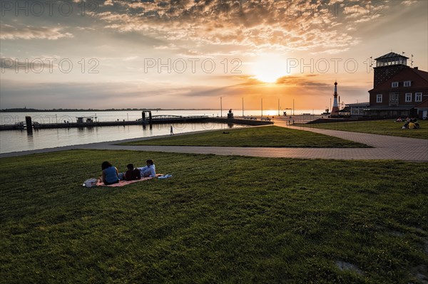 View of the Weser estuary and Strandhalle at sunset from the dyke