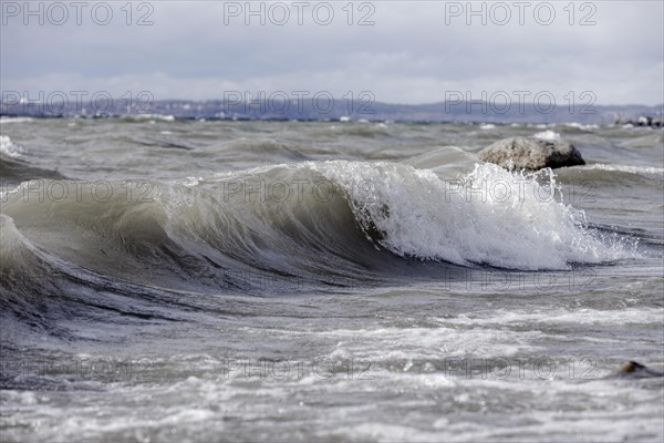 Storm Lolita raging on the rocky shore with waves in Hagnau