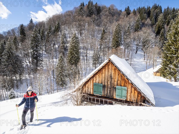 Snowshoe hiker in winter landscape