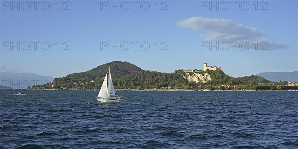 Sailing boat and castle of Angera or Rocca Borromeo di Angera