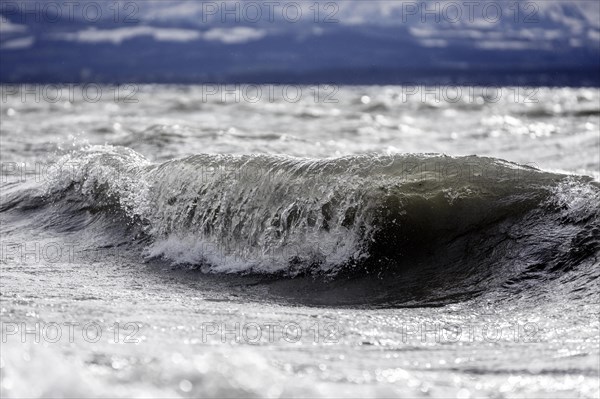 Storm Lolita raging on the rocky shore with waves in Hagnau