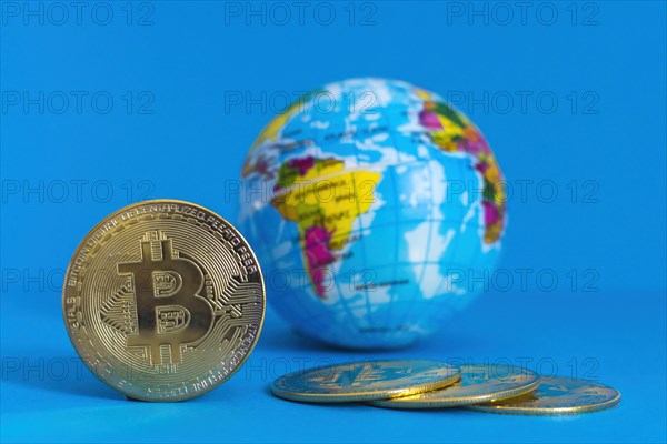 Bitcoin BTC crypto currency gold coin and Earth globe