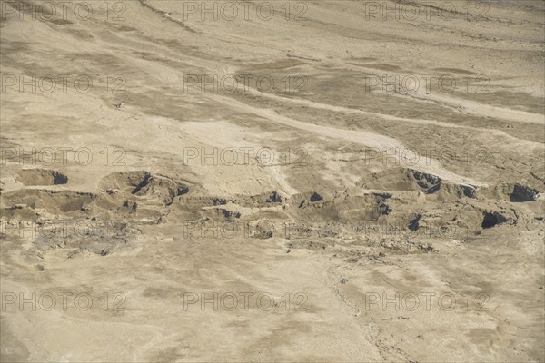 Desiccated desert formation with swallow holes at the Dead Sea