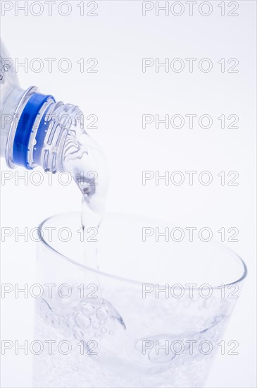 Mineral water is poured into a glass