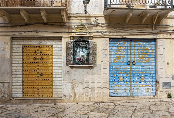 Colorful painted roller shutters on shop display window