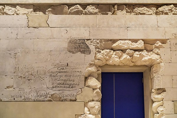 Stone fragments of the 1945 Reichstag ruins reused with original Russian writing