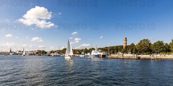 Sailing boats on the river Trave in front of the Trave promenade