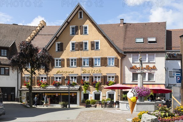 Historic building of the Butsch butcher's shop and Demetrius fountain on the town hall square in Loeffingen