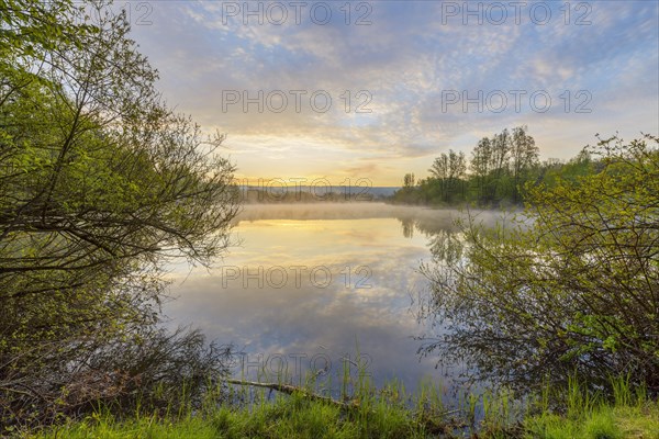 Lake with morning mist at sunrise