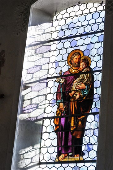 Leaded glass window with saint figure