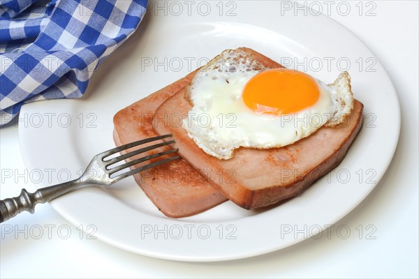 Two slices of meat loaf with fried egg on plate