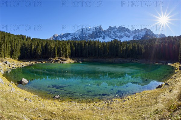 Carezza lake with sun