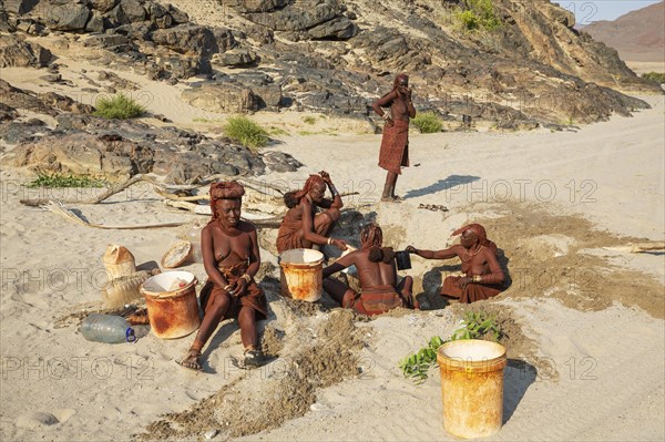 Himba women collecting water at a water hole