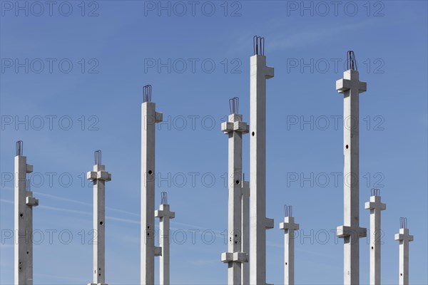 Concrete columns of an industrial hall against a blue sky