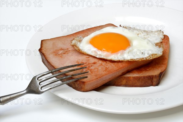 Two slices of meat loaf with fried egg on plate