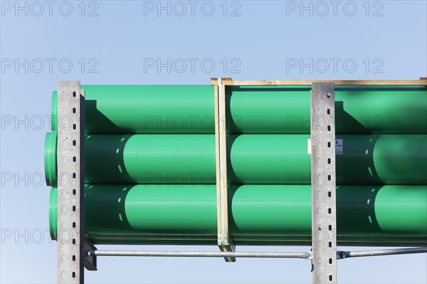 Green plastic sewage pipes in a warehouse for building material