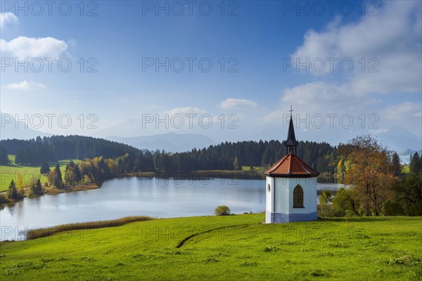 Lake Hegratsried with little Gothic chapel in autumn