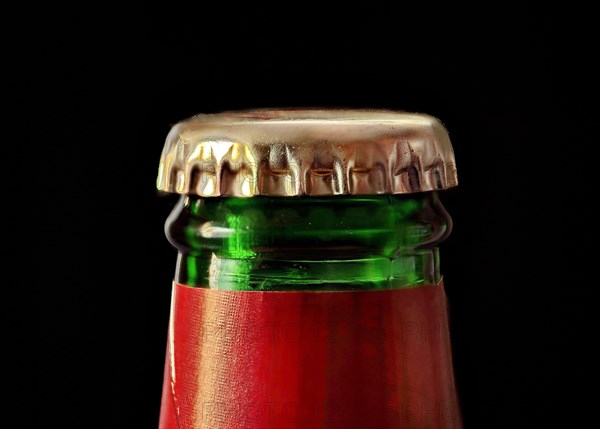 Green beer bottle with gold coloured crown cork