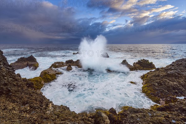 Lava rock coast at Dawn with breaking waves