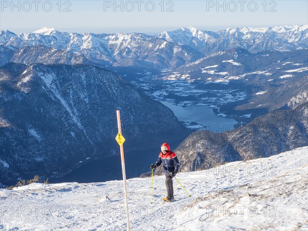 Snowshoe hiker on the Five Fingers trail in winter landscape